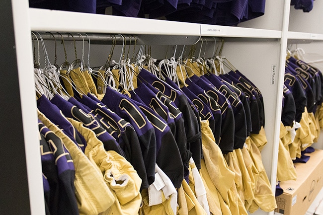 Football Jerseys Stored on Shelving with Hanging Rods